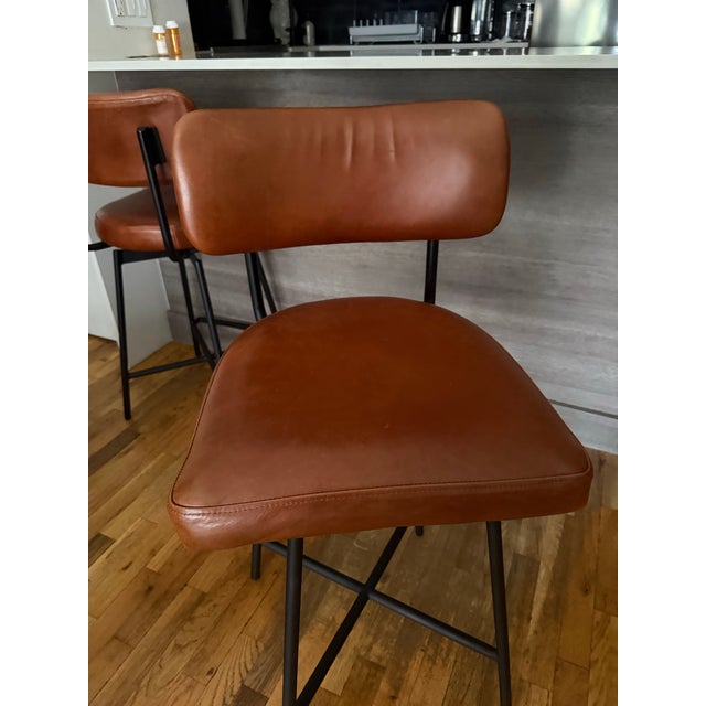These are the West Elm Slope Leather Swivel Counter Stools (or Bar Stools, depending on height) in Cognac top-grain...