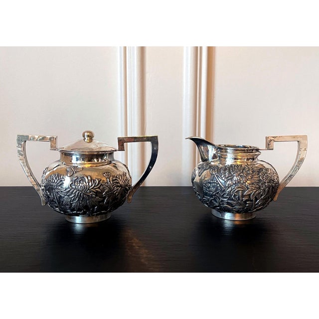 A two-piece set sterling silver creamer and sugar signed "CUT" and "TienXing" in Chinese, circa second half of 19th...