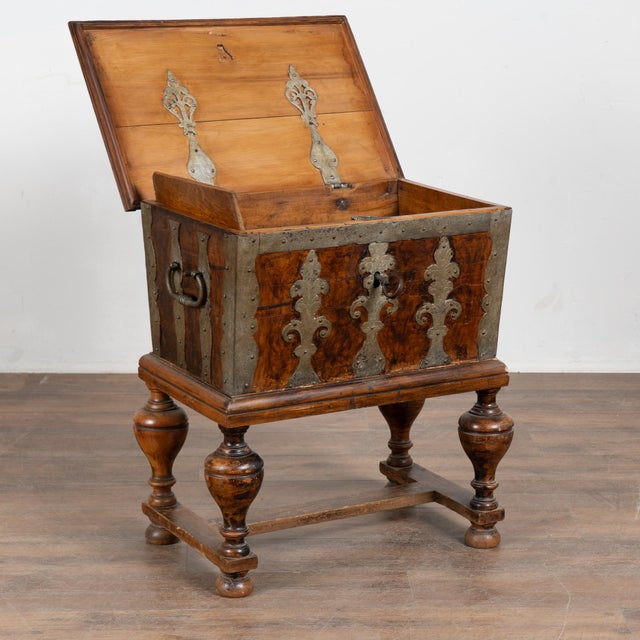 Early 19th-century Swedish trunk or lockbox crafted in pine and raised on turned legs with a stretcher base, creating a...