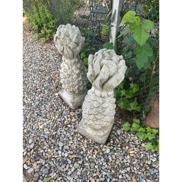 Stylish pair of neoclassical concrete pineapple sculptures for the garden. Heavy concrete construction with lovely age...