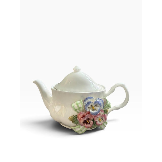 Beautiful vintage Kaldun & Bogle ceramic teapot featuring an elegant ivory body adorned with an elaborate dimensional...
