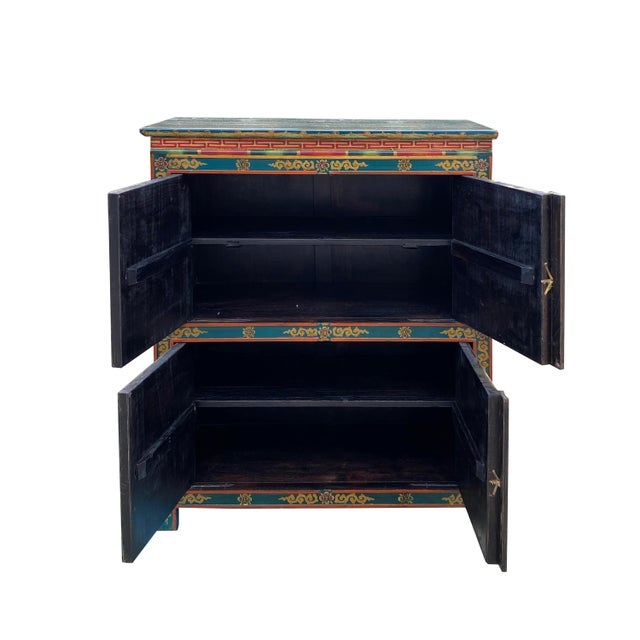 This is a medium-tall cabinet with a colorful Tibetan-style flower graphic at the front as a decorative accent. It can be...