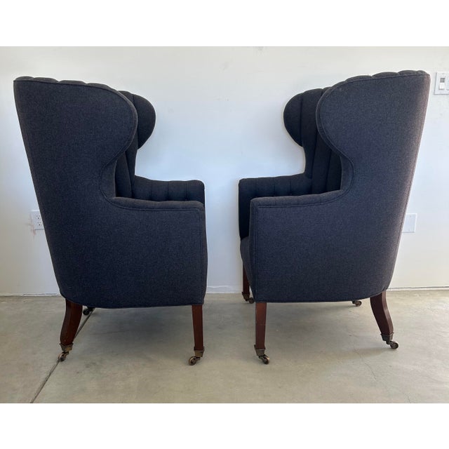 A pair of bench-made wingback armchair by Cisneros Upholstery of Chicago, modeled after an antique English Georgian...
