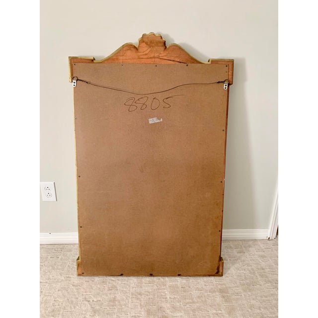 Beautiful architectural details top this vintage mirror frame with a large shell on top, paired on each side with elegant...