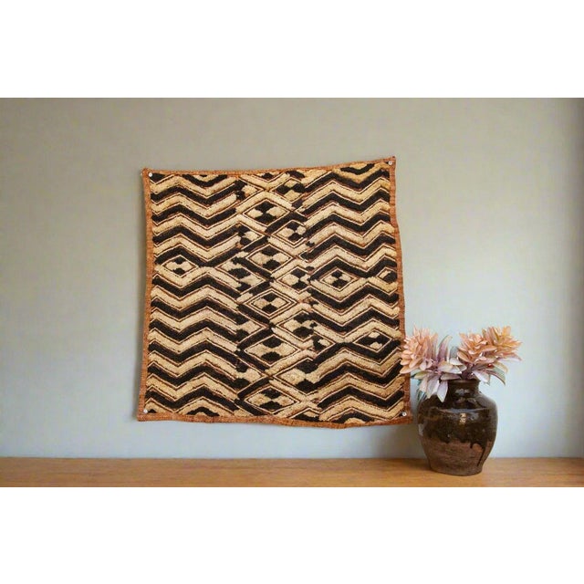 A captivating masterpiece of African textile art, this vintage Kuba cloth panel is a testament to the unparalleled...