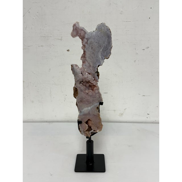 Design Plus Gallery presents a Pink Amethyst Crystal Slab on Stand. This natural specimen displays soft blush and pale...