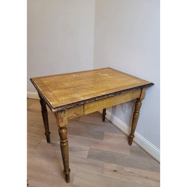 A heavily worn and distressed hand painted yellow faux wood grain farmhouse kitchen work table. Hand-crafted of solid...