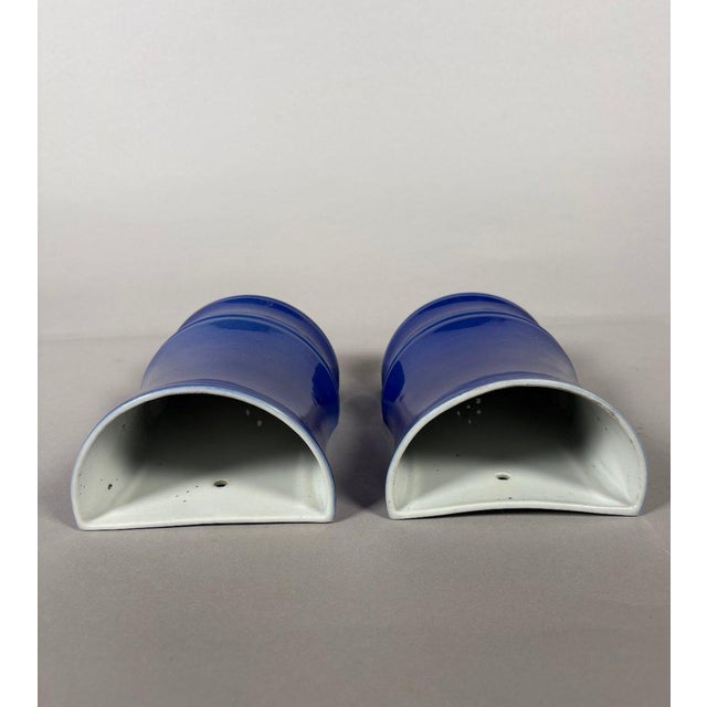 Pair of monochrome blue porcelain wall vases - China, Qing Dynasty, 19th century. Powder blue glazed porcelain in the...