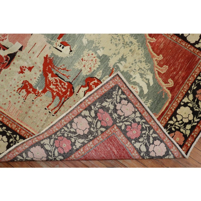 A pictorial Russian Karabagh rug depicting a bunch of reindeers floating around a lady. The background is a tomato red,...