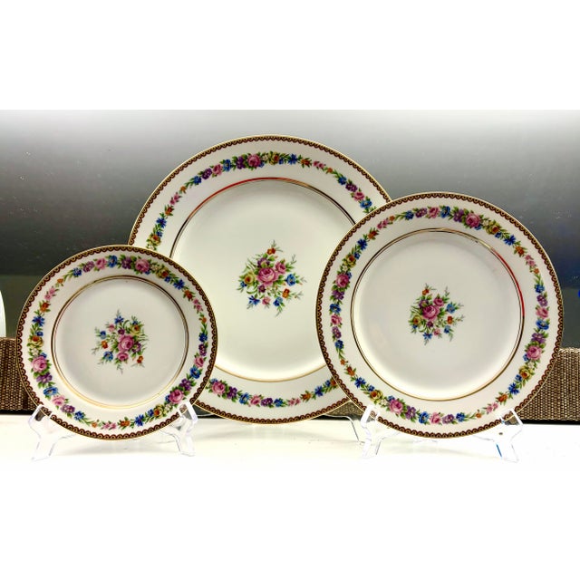 Mid Century Raynaud & Cie Limoges porcelain in the RYD33 pattern, featuring its yellow border, multicolor floral ring, and...