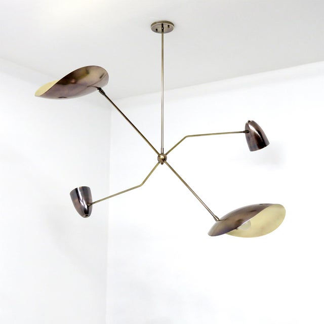 Elegant aged brass chandelier by Gallery L7, handcrafted and finished in Los Angeles from American brass, with four brass...