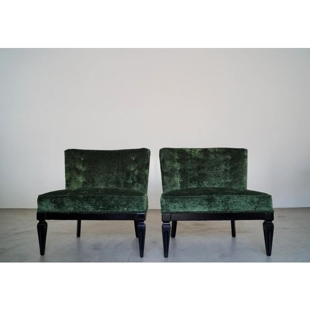 Pair of vintage 1960's Hollywood Regency slipper chairs for sale. They have a solid wood base that have been refinished in...