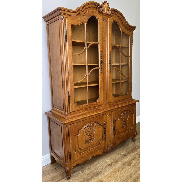 This elegant Vintage French Louis Oak Bookcase is a beautifully crafted display cabinet featuring an impressive shaped...