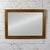 Marvelous vintage wall mirror by Thomasville composed of a rectangular oak frame with a brass plated decorative detail....