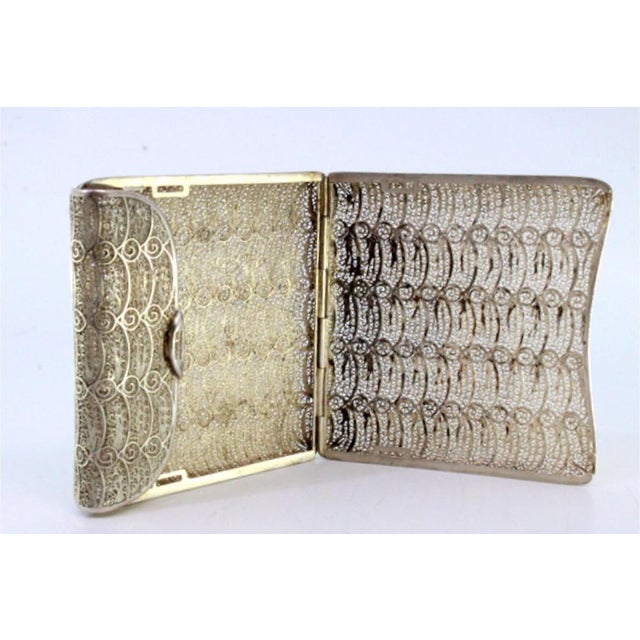 Silver Filigree Cigarette Case with Spring and Hinged Lid, in Very Good conditions. Designed from 2000 This piece has an...