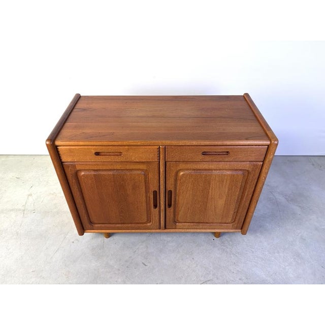 Mid-century teak cabinet from Dyrlund. It features two doors and two drawers. Very good condition, beautifully crafted...