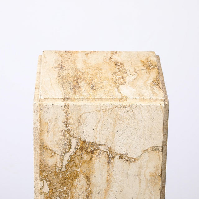 This Mid-Century Modernist rectilinear travertine pedestal, crafted in Italy circa 1970, showcases the sophisticated use...