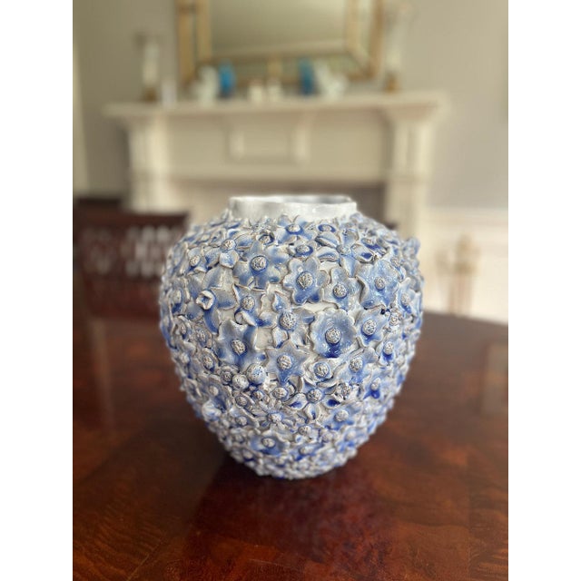 Behold the epitome of refined beauty in the handmade large round light blue ceramic flower vase. Meticulously crafted, its...