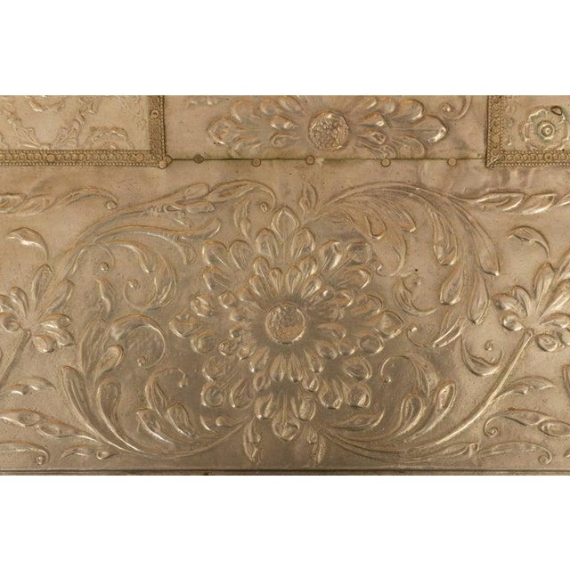This is an exceptional hand-crafted two-drawer chest completely clad in intricately repoussé-worked white metal,...