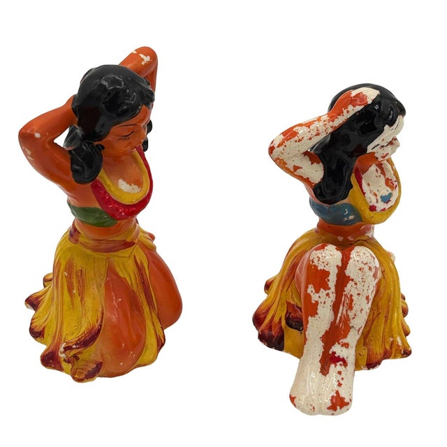 Mid-century Era brown and yellow hula girl ceramic figure set. Each sculptural figure features a beautifully detailed pink...