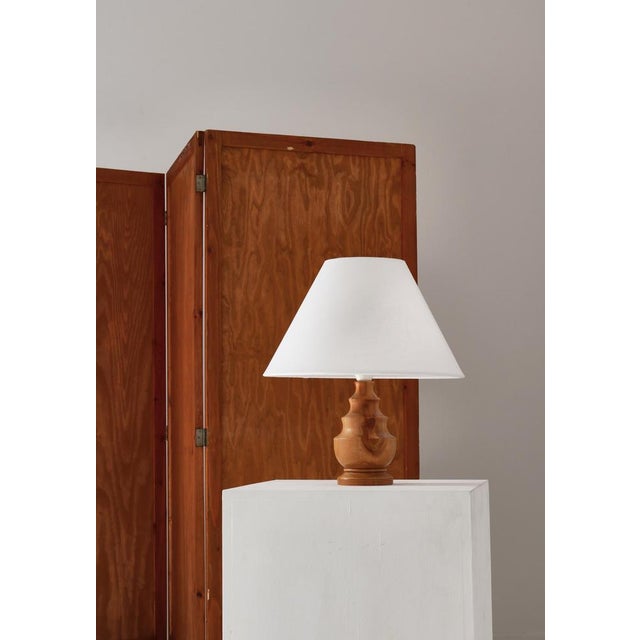 Charming table lamp handmade in Denmark in the 1940s from solid turned wood. The lamp is skillfully made and signed with...