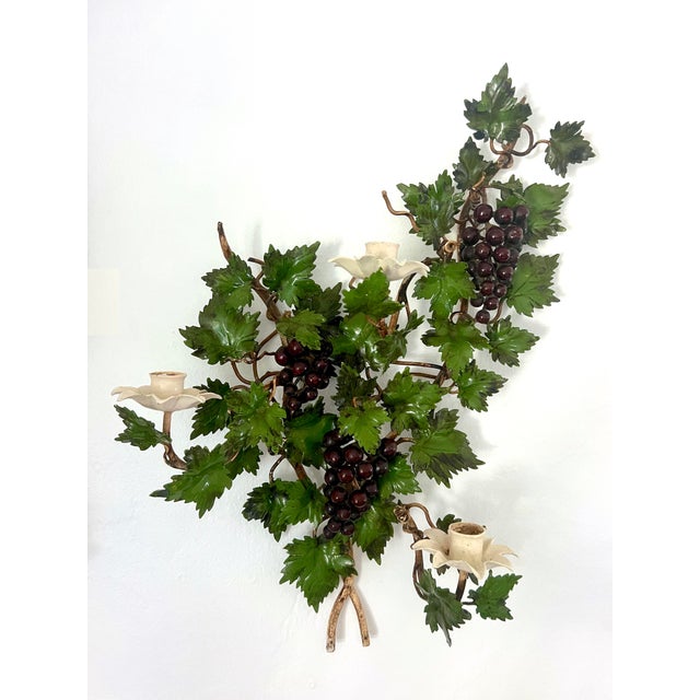 Pair of large 1950's Italian hand painted tole, 3 candle grape and vine leaf wall sconces. Each is realistically designed...