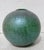 Cast glass green globe with crackle texture and blue-green, red flash surfaces. The globe is bottle green, with a surface...