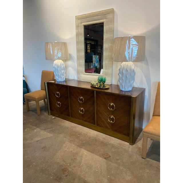 Rosewood with ebony inlay in a chevron pattern encased in a wide brass trim with custom round brass pulls. Handsome and...