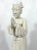Attractive figurine of a young Chinese girl made from white porcelain called Blanc de Chine. Posing on a base of waves in...