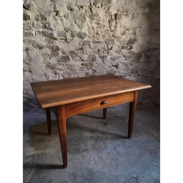 Antique French walnut dining table dating from circa 1900. The table has a rectangular top made from several wide walnut...