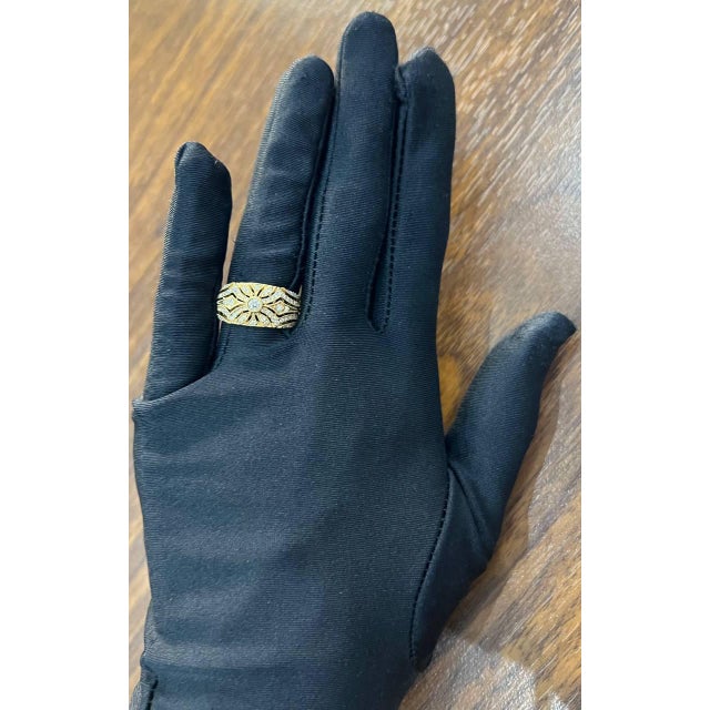 This captivating piece, made from 14K yellow gold, features a central design adorned with 0.57 carats of white diamonds....