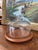 A mid-century modern cheese dome featuring a clear blown-glass cloche paired with a warm, solid teak wood base. While hard...