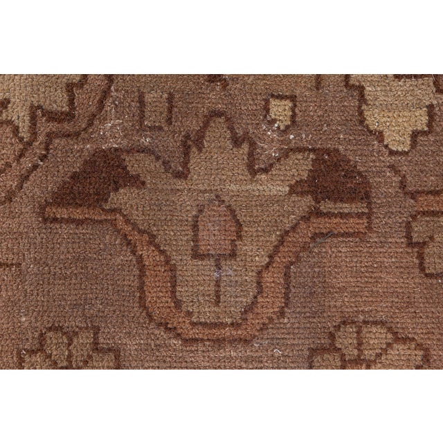 An early 20th century Persian Malayer rug, the abrashed camel field with a subtly colored allover design of stylized...