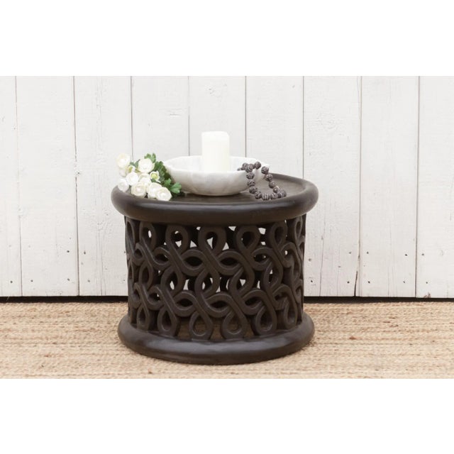 This extraordinary Bamileke table, an exceptional piece carved from a single tree trunk. This African coffee table is...