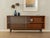 Sideboard from the 1960s by Wilhelm Renz. High-quality body in teak veneer with two glass sliding doors, two shelves, and...