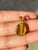 This is part of Chairish’s Fine Jewelry assortment. Tiger's eye pendant in 18K Gold. It has a oval cut gemstone that...