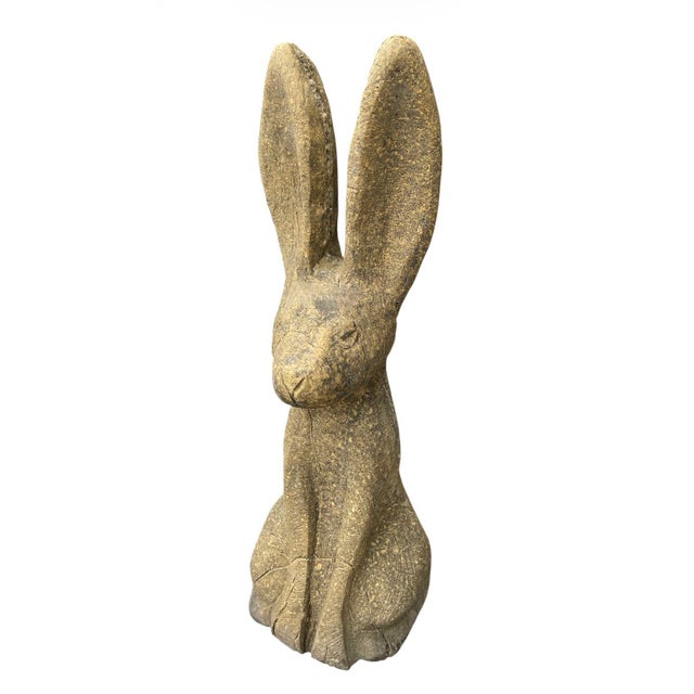 A striking vintage garden sculpture crafted from heavy cast stone, depicting a seated jackrabbit in a stylized, modern...