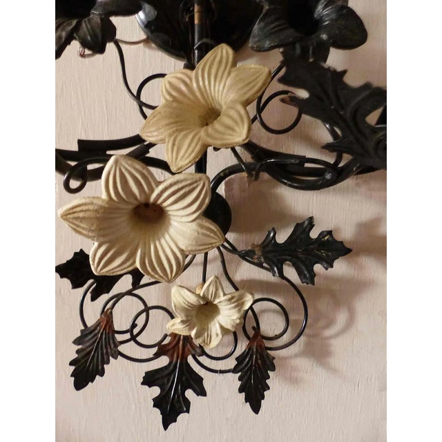 Antique 1930's Italian Tole, seven light, candelabra style, tiered wall sconce having elegant black frame. Sconce has the...