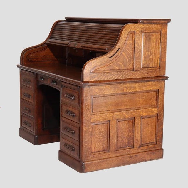 Antique Derby Oak Raised Panel S-Roll Top Desk with Carved Pulls c1920. 50 3/8" x 55 1/8" x 35 5/8". This antique Derby...
