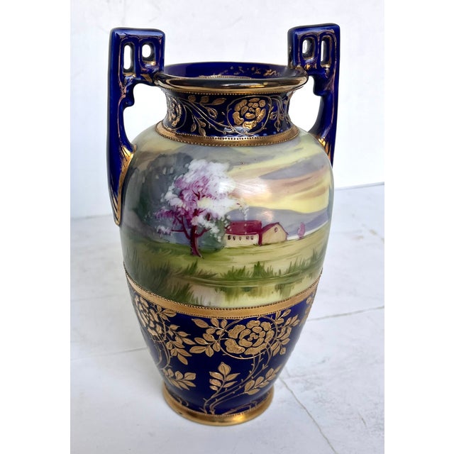 Nippon porcelain was created in Japan prior to 1921. This lovely vase features a hand painted landscape with a house and...