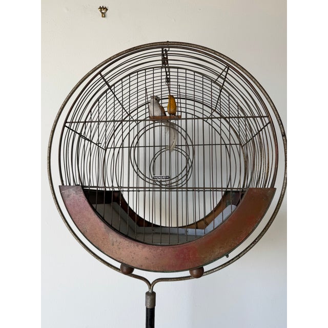 Striking vintage Hendryx birdcage featuring a rare Art Deco “hatbox” silhouette, mounted on its original floor stand....