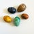 A set of 5 decorative stone eggs. Beautiful colors and veining to the stone. Varying sizes, measuring from 2 to 2.75"L and...