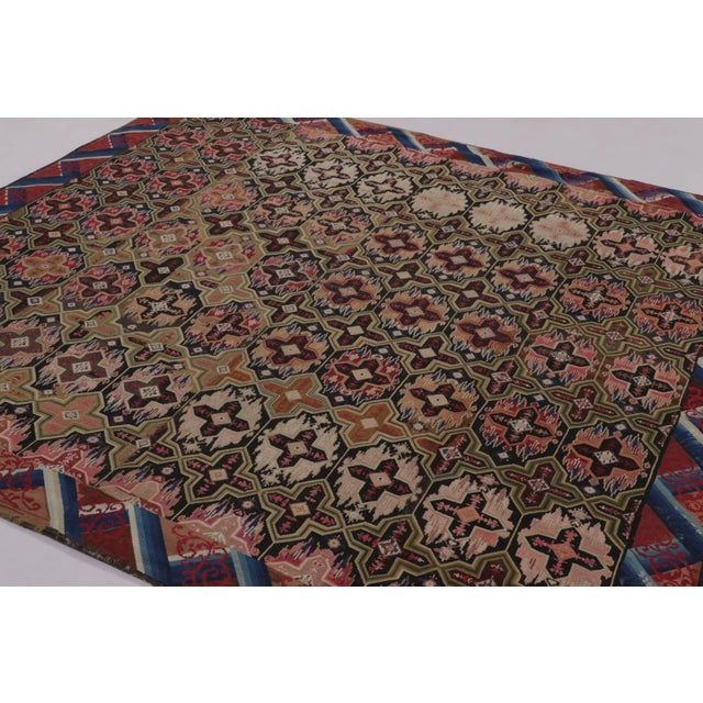 Originating from the refined traditions of late 19th-century England, this 8x10 antique needlepoint rug is a masterpiece...