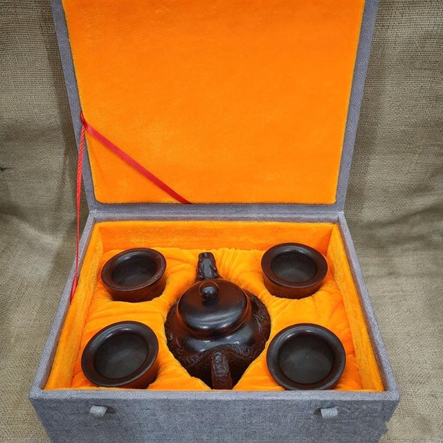 This is a striking vintage-style tea set, meticulously carved to resemble dark horn or wood, featuring a dragon motif and...