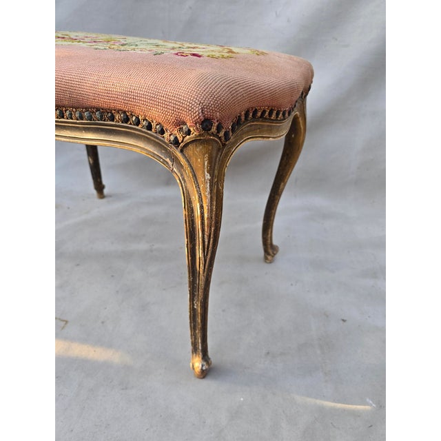 This is a vintage french bench with a pink needlepoint cover. This would be perfect in a dressing room, at a dressing...