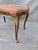 This is a vintage french bench with a pink needlepoint cover. This would be perfect in a dressing room, at a dressing...