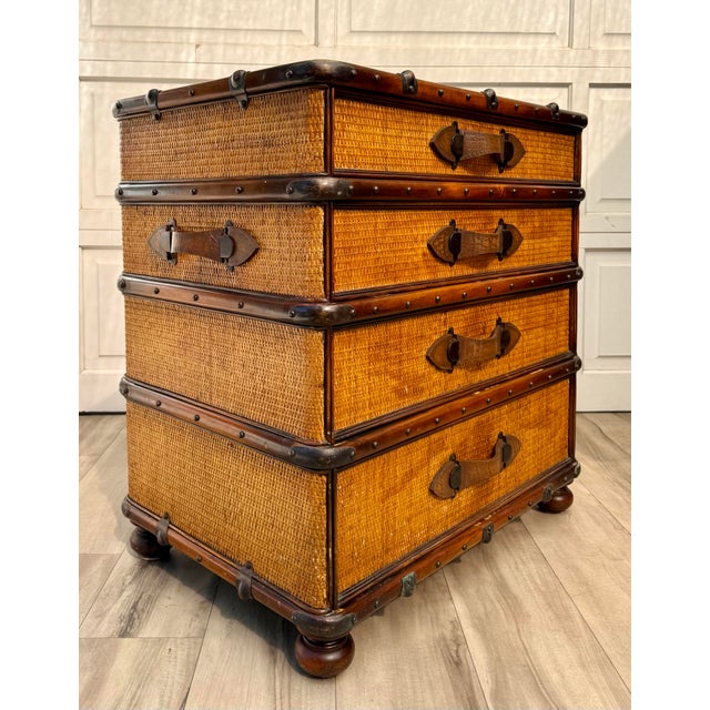 A distinctive vintage British Colonial-style four-drawer chest, believed to date to the later 20th century, featuring a...