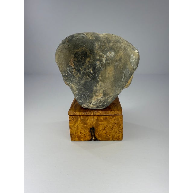 Ceramic head sculpture, possibly of Asian origin, with a very serene expression. Dark Gray in color overall with evident...