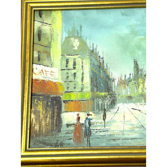 A charming pair of 1950s Paris street scene oil paintings capturing the romantic atmosphere of mid-century European city...
