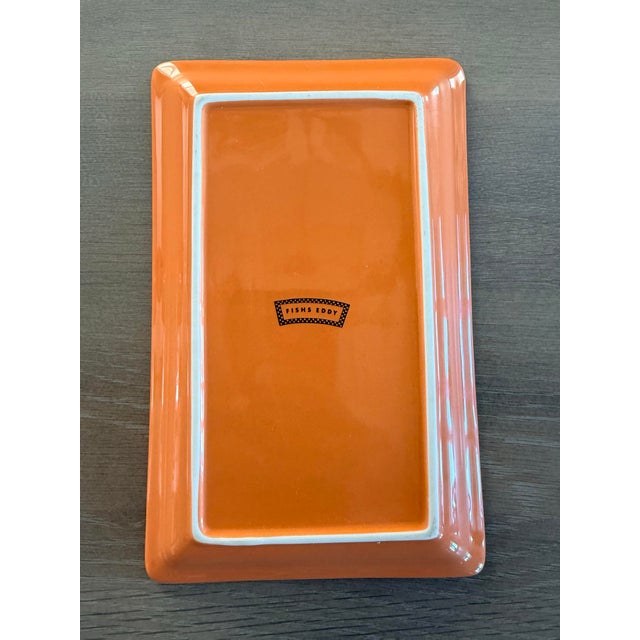 Whimsical tray in the form of a parking ticket. This was made by Fishs Eddy NYC. The bright orange is eye catching and...